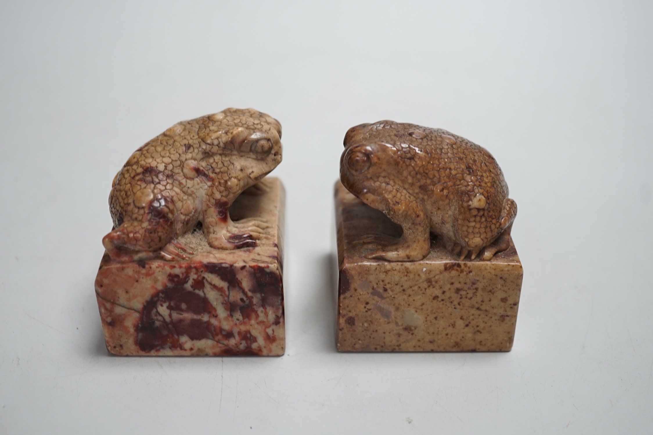 A pair of Chinese carved soapstone chop seals decorated as seated toads, 6cm